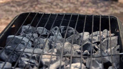 Coals are burned in a BBQ grill Stock Footage