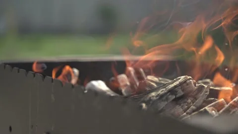 Coals burn through on the grill before putting a barbecue on it Stock Footage 128799506