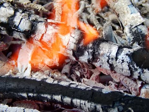 Coals of a burning campfire close up Stock Photos