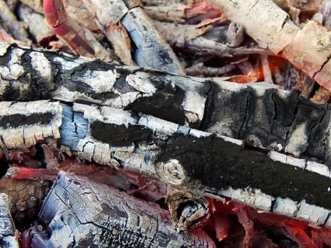 Coals of a burning campfire close up Stock Photos