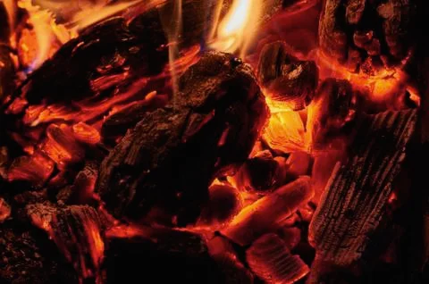 Coals in a fire close-up at night Stock Photos