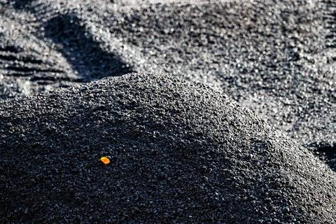 Coarse Black Material with a Single Orange Detail Stock Photos