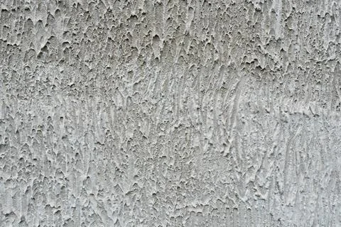 Coarse grey textured plaster wall background full frame close up for Stock Photos