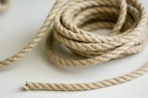 Coarse rope roll on a white surface Stock Photos