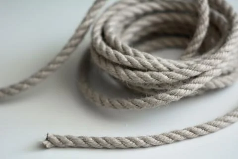 Coarse rope roll on a white surface Stock Photos