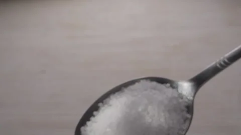Coarse salt crystals on a silver spoon. Stock Footage 285489507