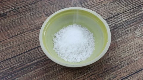 Coarse salt poured into a dish Stock Footage 150585529