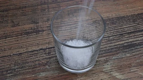 Coarse salt poured into a glass Stock Footage 150614748