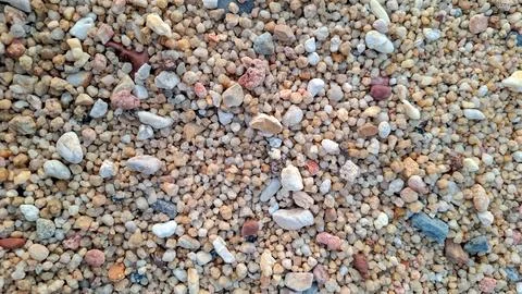 Coarse Sand and Small Pebbles Texture on Tropical Beach Stock Photos