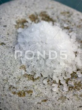 Coarse sea salt on a stone Stock Photos