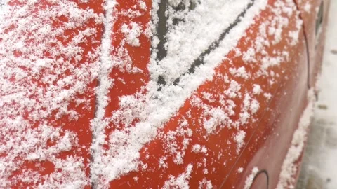 Coarse snow is falling on the door car, snowfall has covered a red car Stock Footage 267210984