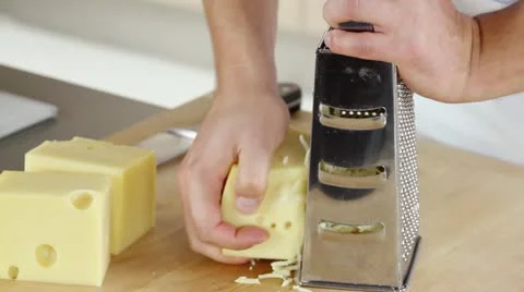 Coarsely grating cheese Stock Footage 24670470