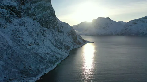 Coast and mountain landscape in winter sun. Drone shot. 動画素材 299569458