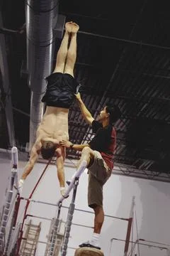 Coast Assisting An Athlete With Parallel Bars Stock Photos
