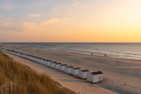 On the coast with beach huts whit the sun go down Stock Photos