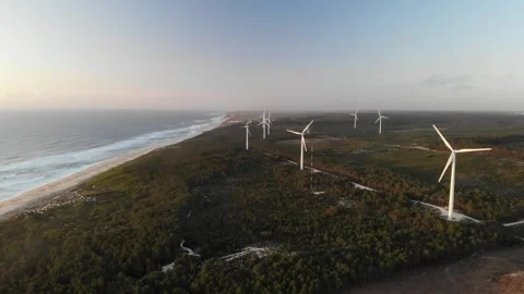 Coast beach sandy with big waves and windmills in the background in portugal Stock Footage 247502079
