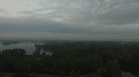 Coast of big river in the mist during dawn, the city on the horizon Video stock 63488440