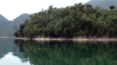 Coast of green mountain river view from boat in Patagonia Argentina. Stock Footage