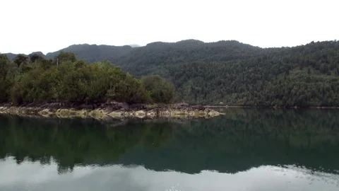 Coast of green mountain river view from boat in Patagonia Argentina. Stock Footage