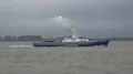 Coast guard boat driving on river at rainy day with dark clouds 4k or 4k+ Resolution