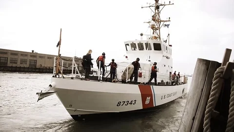 A Coast Guard Boat Pulls Away from Dock co Stock Footage 116617840