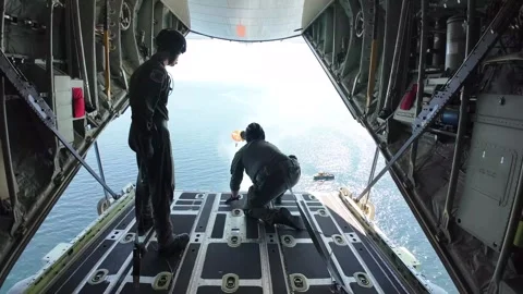 Coast Guard offloading equipment into ocean from C-130 Hercules Stock Footage 285397223