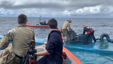Coast Guard seize bales of narcotics from semi-submersible smuggling vessel Stock Footage 120077078