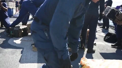 Coast Guard stacking sacks of cocaine seized in Eastern Pacific Stock Footage 81707831