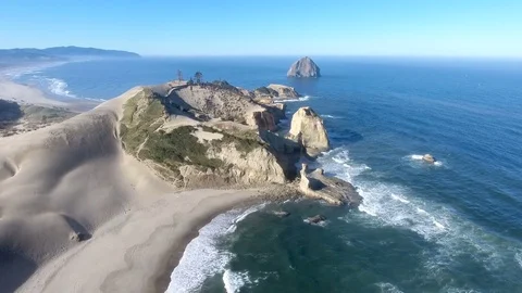 Coast haystack rock sand dune water Stock Footage 81764962