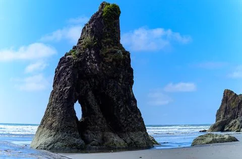The coast of the Pacific Ocean, large cliffs and islands near the shore. Ol.. Stock Photos