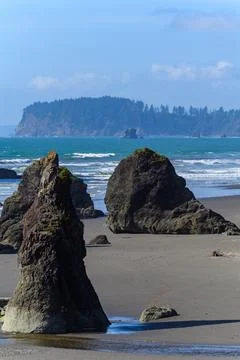 The coast of the Pacific Ocean, large cliffs and islands near the shore. Ol.. Stock Photos