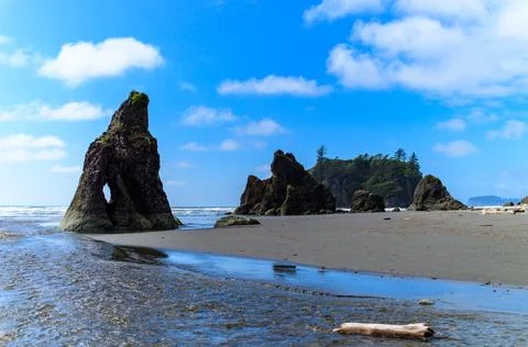 The coast of the Pacific Ocean, large cliffs and islands near the shore, Ol.. Stock Photos