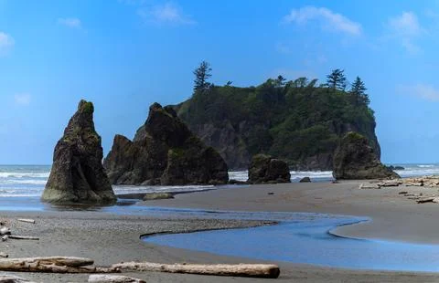 The coast of the Pacific Ocean, large cliffs and islands near the shore, Ol.. Stock Photos