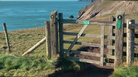 Coast path stile at Giltar Point looking towards Lydstep Stock Footage 239525523