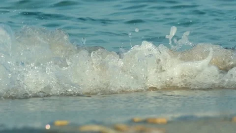The coast of the sea or ocean. Waves are breaking on a sandy beach, foam. Stock Footage