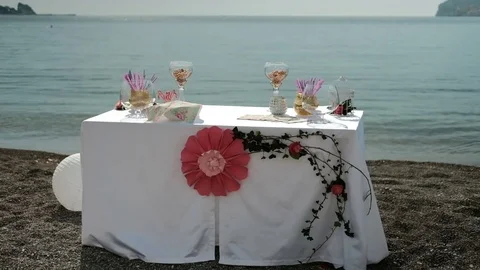 On the coast there is a table with a flower for a romantic date Stock Footage 74691880