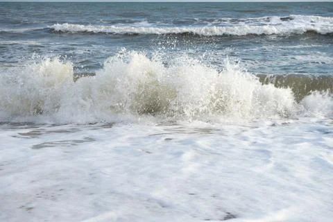 Coast with a wave rolling over it Stock Photos