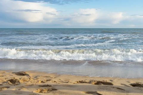Coast with a wave rolling over it Stock Photos