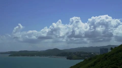 Coastal bay dramatic cloudy sky green hills water Video stock 329543578