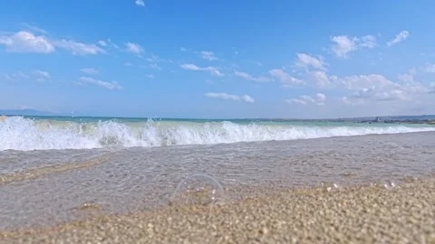 Coastal beach with waves rolling onto wet sand Stock Footage 341776274