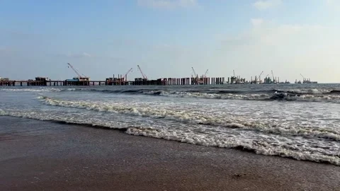 Coastal bridge construction site on sandy beach with sea waves Vídeos de archivo 336628618