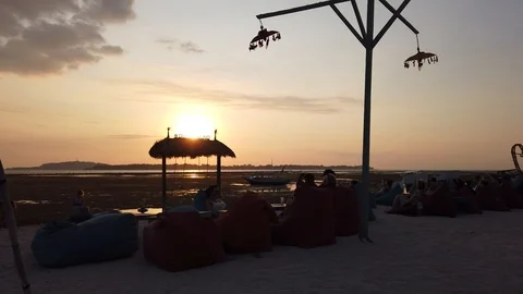 Coastal cafe at sunset, against the backdrop of a strong low tide. Stock Footage 111792184