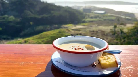Coastal Clam Chowder with Bread and Ocean Horizon Stock Footage 306251084