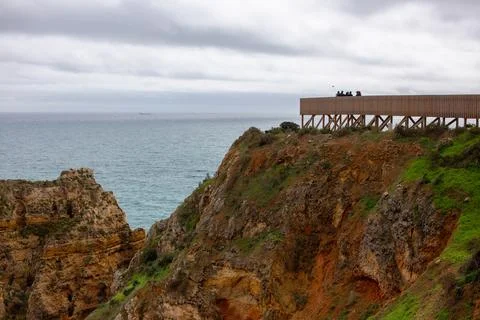 Coastal Cliff Viewpoint, Cliffs overlooking the ocean on a cloudy day. Lagos Stock Photos
