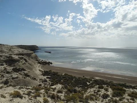 Coastal cliffs and beach in peninsula valdes, patagonia Stock Photos