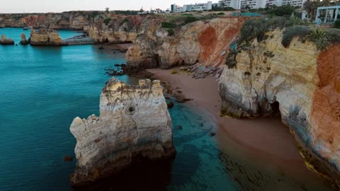 Coastal cliffs and clear waters along the shoreline of Portugal Stock Footage 312326185