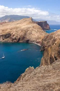 Coastal Cliffs and Ocean View with a Sailboat Stock Photos