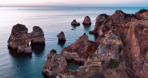 Coastal cliffs and rock formations along the shores of Portugal at sunset Stock Footage 312326588