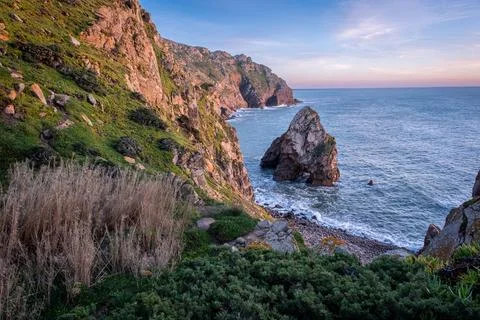 Coastal cliffs and rock formations at sunset, Cabo da Roca, Portugal Stock Photos