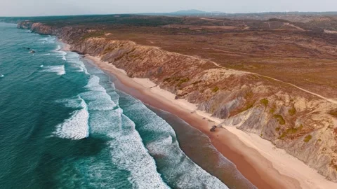 Coastal cliffs and serene waves along Portugal's southern shoreline Stock Footage 312328689